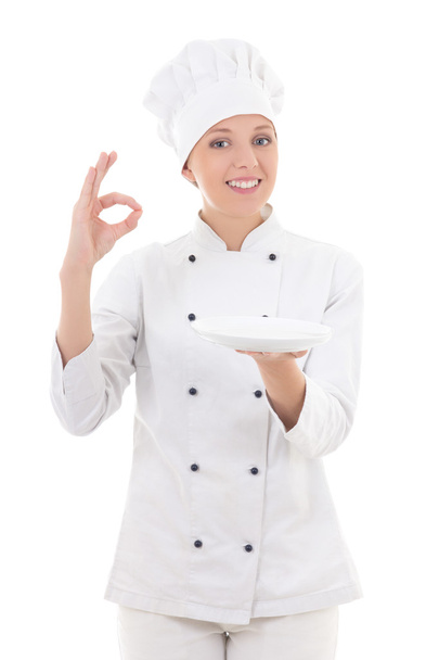 молода жінка шеф-кухар в уніформі тримає порожню тарілку і показує добре s
 - Фото, зображення