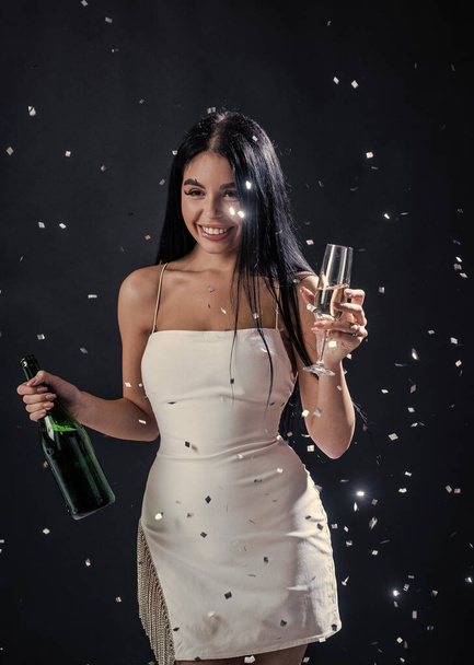 glamour woman having fun under falling confetti. sexy woman drink champagne and glass. - Zdjęcie, obraz