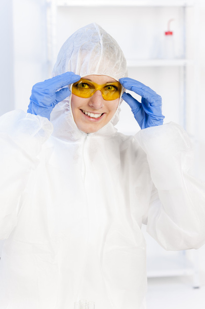 молода жінка з захисними окулярами і пальто в лабораторії
 - Фото, зображення
