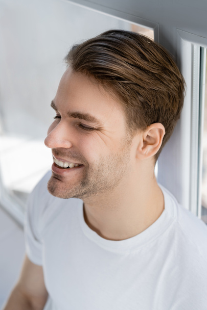 high angle view of young man smiling with closed eyes - Foto, Bild