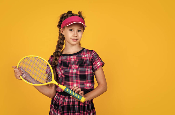 child hold badminton racket. kid tennis player. back to school. happy and healthy childhood - Foto, Imagen