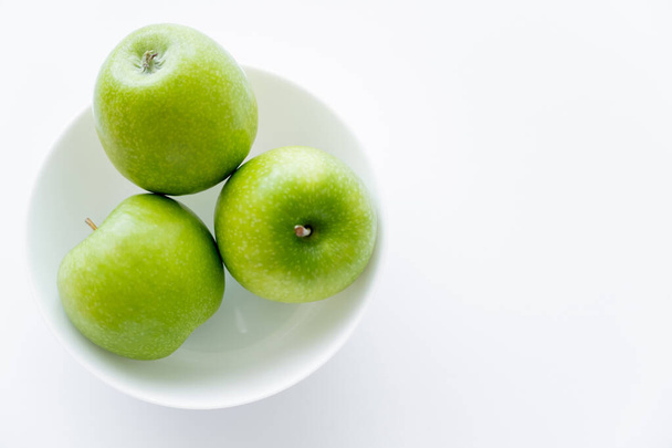 top view of fresh apples in bowl on white - Photo, image
