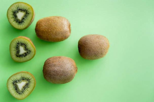 top view of fresh kiwi fruit on green - Фото, изображение