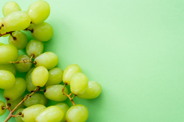 top view of ripe and organic grapes on green - Photo, image
