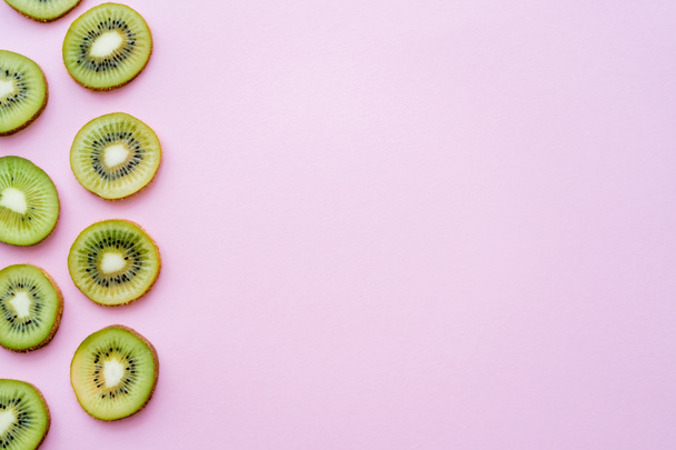 top view of sliced juicy kiwi on pink with copy space - Foto, immagini