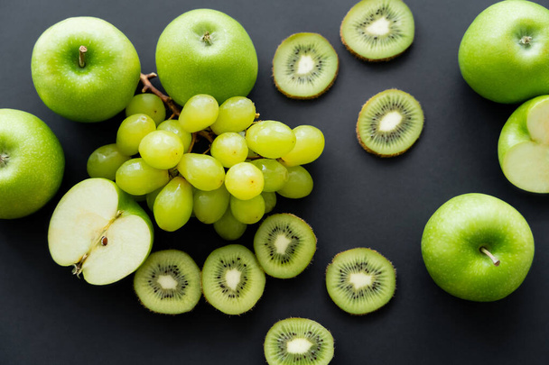 top view of green fresh fruits on black  - Фото, изображение