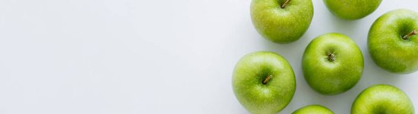 top view of whole green apples on white with copy space, banner - Foto, imagen