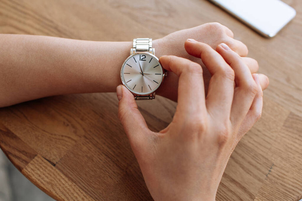 wristwatch on the girl's hand. metallic. High quality photo - Foto, Bild
