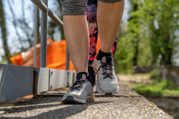 women running on a concrete bridge wearing sportswear - healthy lifestyle concept - Φωτογραφία, εικόνα