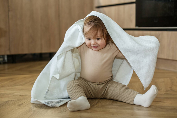 Toddler girl plays and has fun, hide-and-seek. Cozy house. - Photo, Image