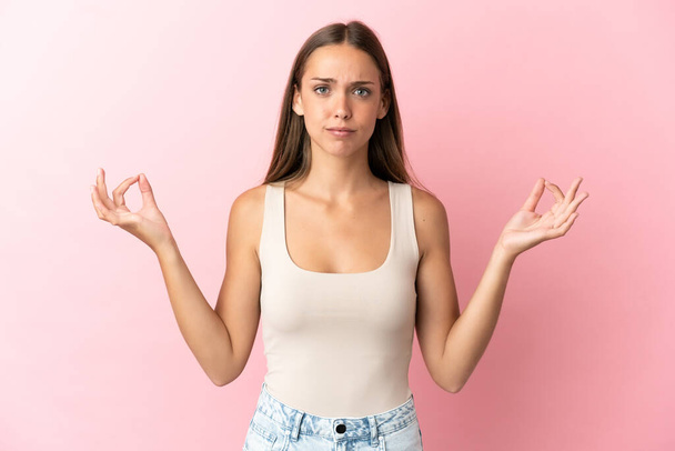 Young woman over isolated pink background in zen pose - Φωτογραφία, εικόνα