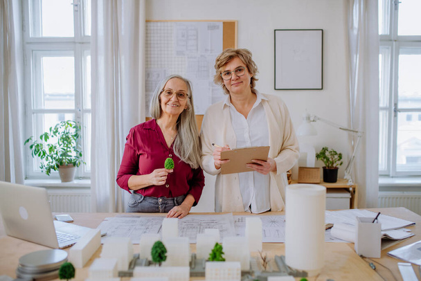 Mature women architects working together in office, looking at camera. - Foto, Imagem