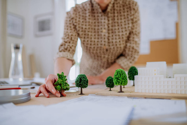 Close-up of woman architect with model of houses in office - Photo, Image
