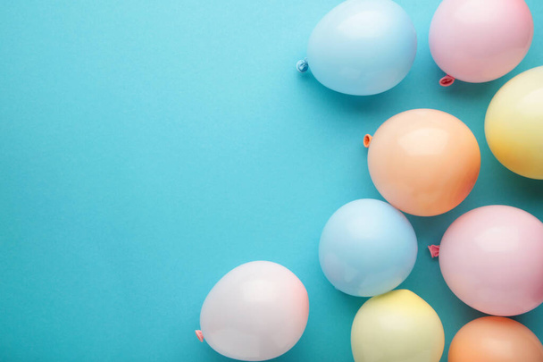Birthday background with colorful balloons on blue background, top view. Happy birthday - Photo, Image