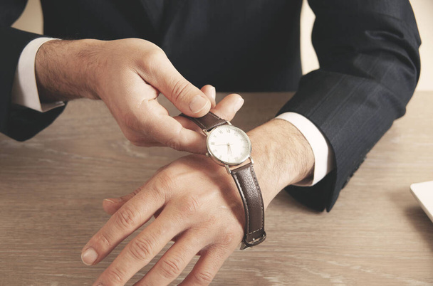 young business man hand watch  in office - Фото, изображение
