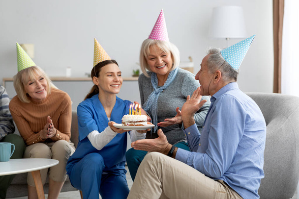 Handsome senior man celebrating birthday at assisted living - 写真・画像