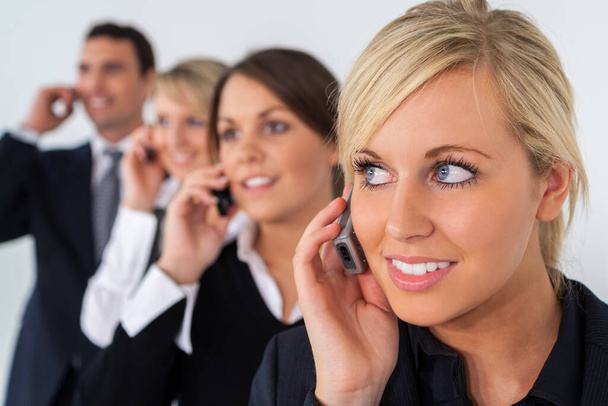 Businessman and businesswoman, male and female, talking on cell phones, business men and women team. - Foto, afbeelding