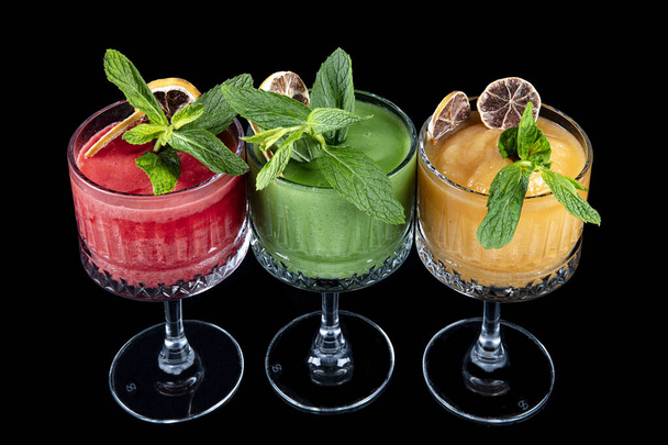 Frozen drink. Frozen strawberry and kiwi and pineapple smoothie with ice cubes. - 写真・画像