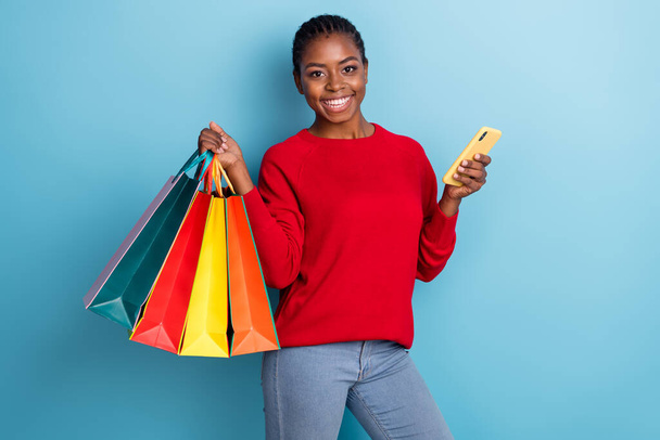 Photo of sweet millenniaal brunette lady hold telephone do shopping wear red shirt isolated on blue color background - Valokuva, kuva