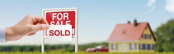 Real estate agent hanging a sold sign after a successful property sale - Фото, изображение