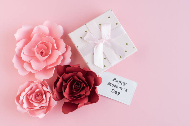Paper roses with HAPPY MOTHER DAY card and gift box with ribbon on pink background. Copy space. Greeting card. - Фото, изображение