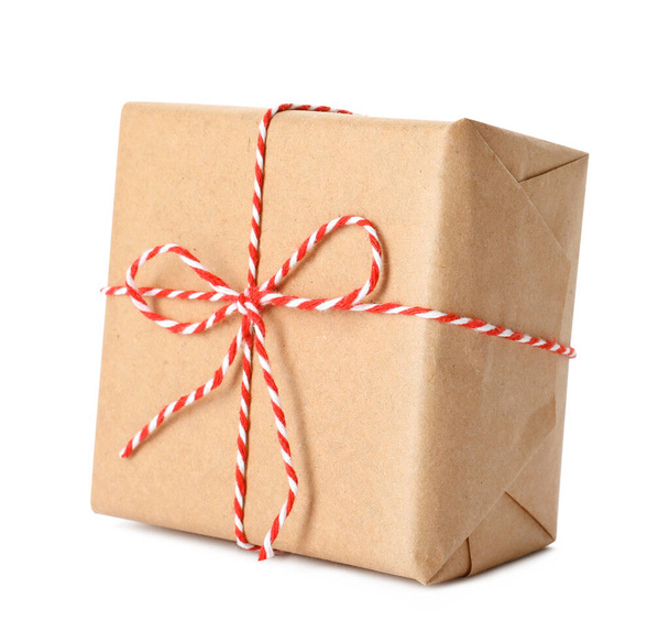 Gift box wrapped in kraft paper with bow isolated on white - Fotó, kép