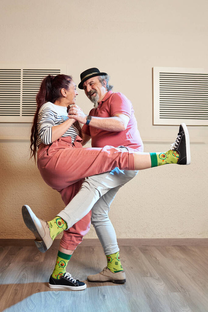 A man and a woman dancing Lindy Hop in a dance studio - 写真・画像