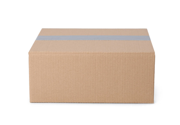 One closed cardboard box isolated on white - Foto, Imagen