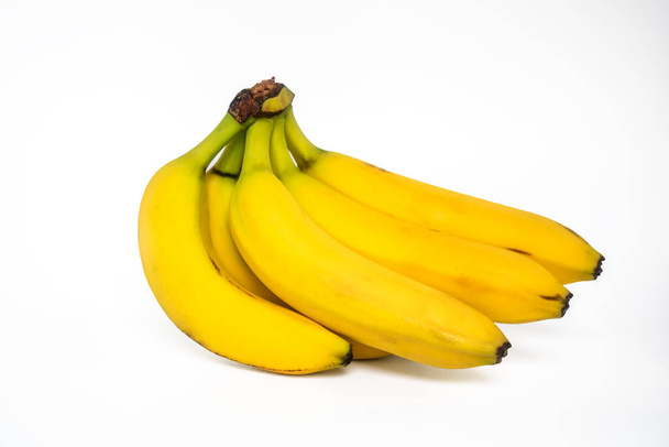白を基調とした単黄色のバナナ - 写真・画像