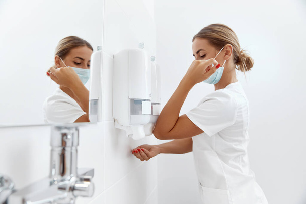 Surgeon washing hands before operating in hospital. Health care and hygiene concept - Zdjęcie, obraz