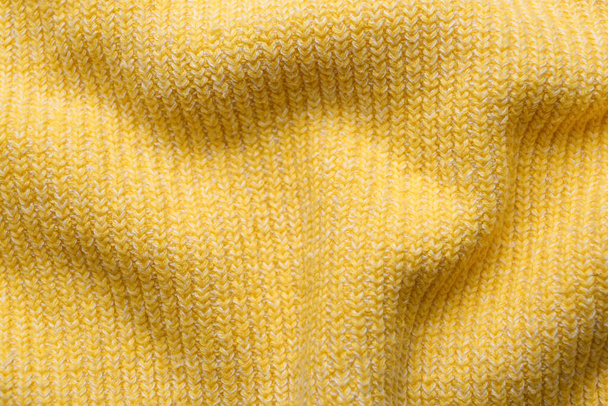 Yellow knitted fabric as background, top view - Valokuva, kuva
