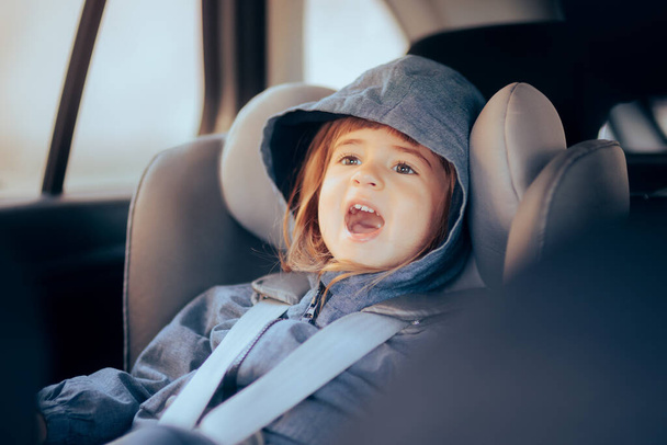 Cheerful Child Sitting in Car Chair Ready to Travel - Photo, image