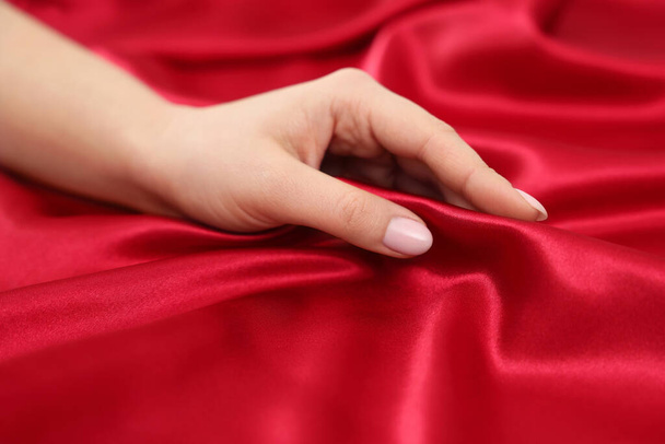 Woman touching smooth silky fabric, closeup view - 写真・画像