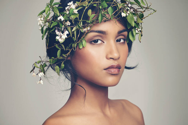 Goddess of nature. Studio portrait of a beautiful young woman wearing a head wreath. - 写真・画像