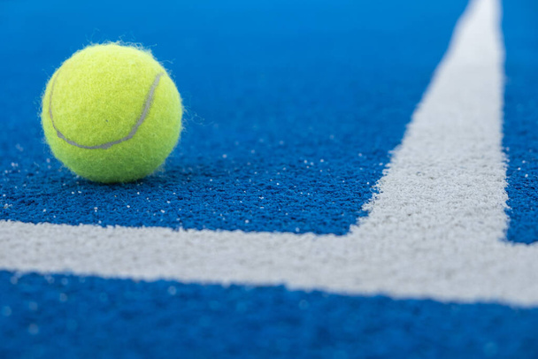 tennis ball on a blue background - Фото, изображение