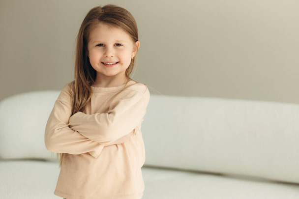 portrait of a cute smiling little girl at home - Fotó, kép