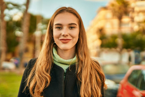 Young blonde girl smiling happy standing at the city. - Φωτογραφία, εικόνα