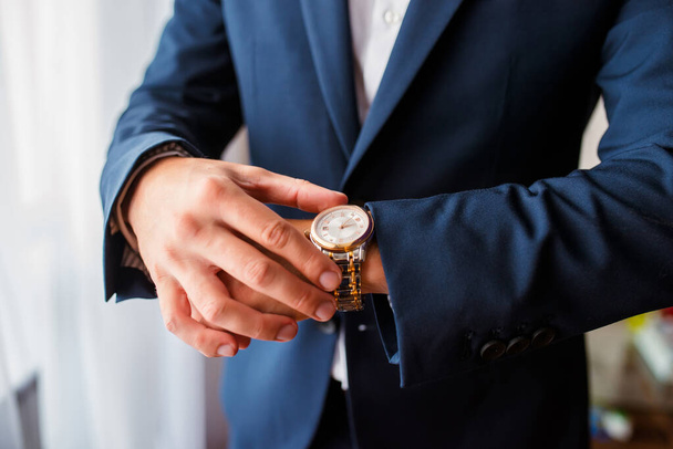 Time is money. Businessman pointing on watch. Business concept. - Foto, afbeelding