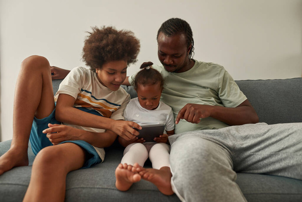 Black father with kids watching on digital tablet - Fotoğraf, Görsel