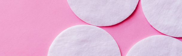 top view of white cotton pads on pink background, banner - Фото, изображение