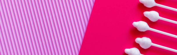 top view of cotton swabs on textured violet and pink background, banner - Фото, изображение