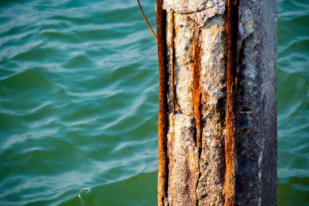 Deniz suyuna maruz kalan sütunlar aşınmış ve paslanmış çelik. - Fotoğraf, Görsel