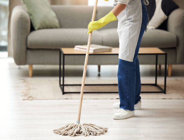 Not always in the mood. Shot of an unrecognizable woman mopping the floors at home. - Foto, imagen