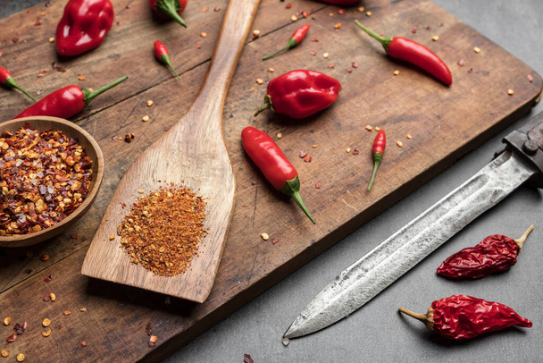 Variety of fresh and dried chili peppers on rustic background - Fotografie, Obrázek