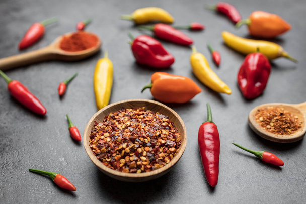 Variety of fresh and dried chili peppers on rustic background - Foto, imagen