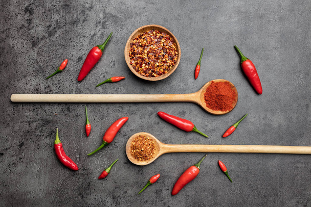 Variety of fresh and dried chili peppers on rustic background - Fotó, kép