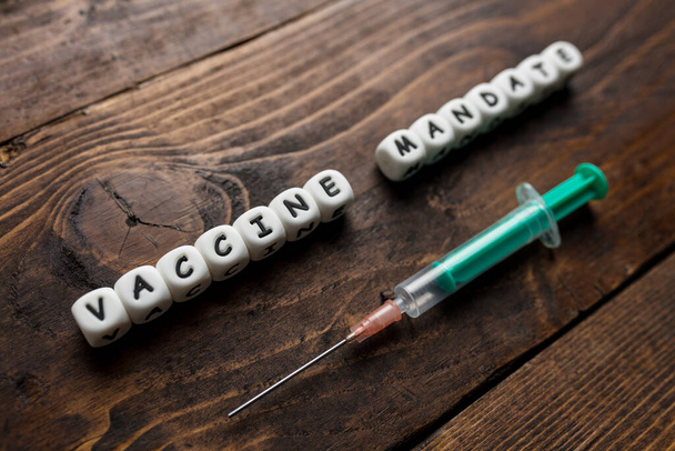 Corona virus Covid-19 vaccine text on wooden background  - Valokuva, kuva