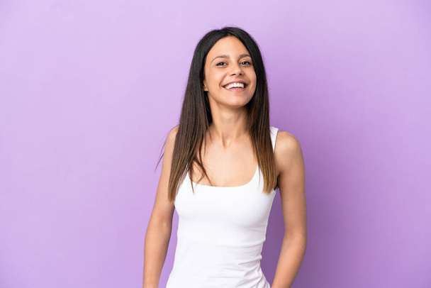 Young caucasian woman isolated on purple background laughing - Fotó, kép