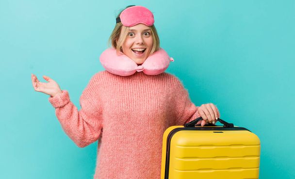pretty blonde woman looking happy and pleasantly surprised. flight passenger concept - 写真・画像