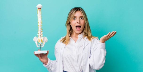 pretty blonde woman feeling happy and astonished at something unbelievable. spine specialist concept - Foto, imagen